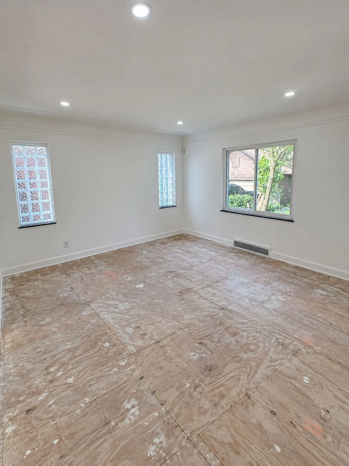 Empty room with a bare, unfinished subfloor